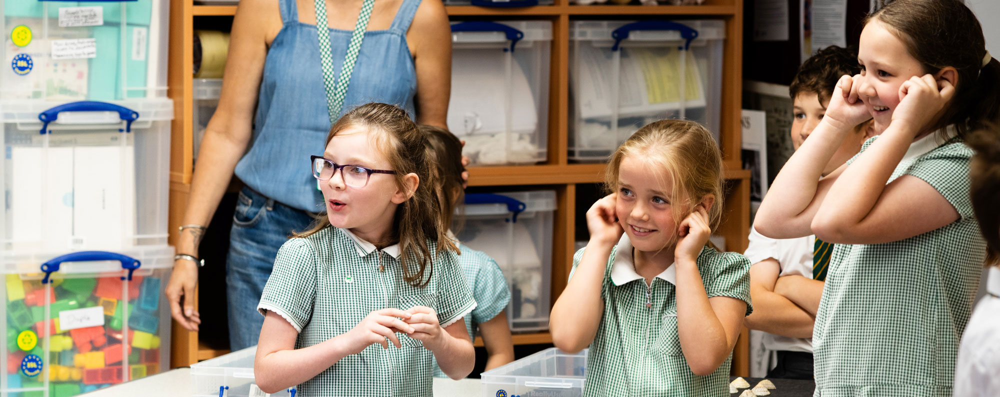 Children on a school visit Children on a school visit with their fingers in their ears looking in wonder off to the left