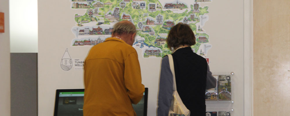 tourist-info-1k Two visitors looking through the tourist information leaflets